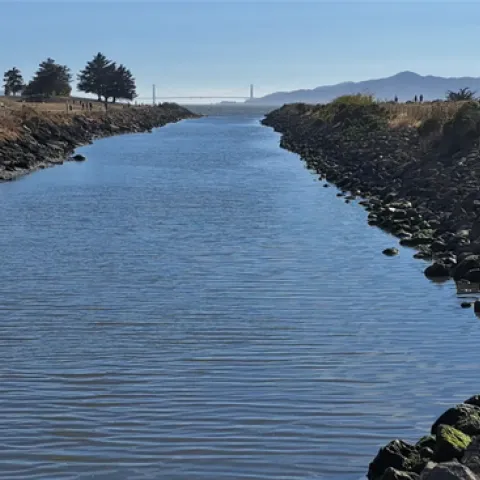 Receiving water flowing out towards San Francisco Bay with Golden Gate Bridge in the distance.