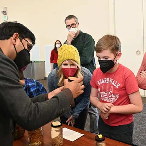 Nematologist Shahid Siddique explains some of the display items during a previous UC Davis Biodiversity Museum Day. (Photo by Kathy Keatley Garvey)