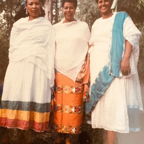 Three black women dressed in traditional Ethiopian attire.