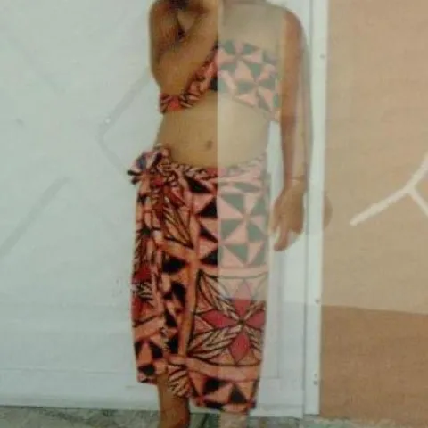 Young girl wearing a two piece outfit poses for the camera.