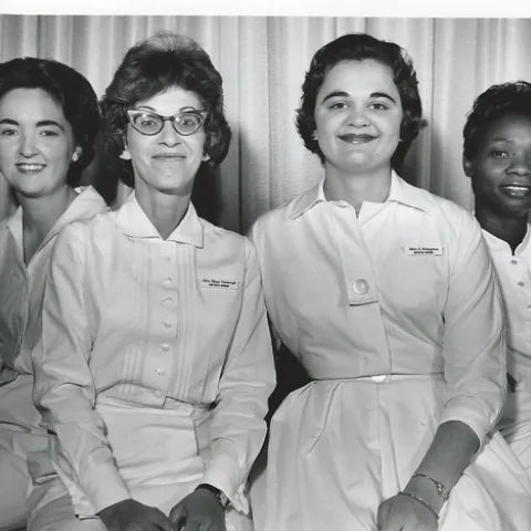 Three Caucasian women and one Black woman