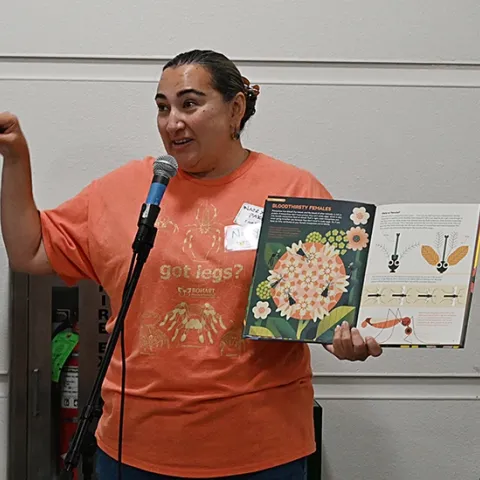 UC Davis alumna Nazzy Pakpour, who holds a doctorate microbiology, virology and parasitology from the University of Pennsylvania, reads from her children's book, "Please Don't Bite Me," at a recent Bohart Museum of Entomology open house. (Photo by Kathy Keatley Garvey)