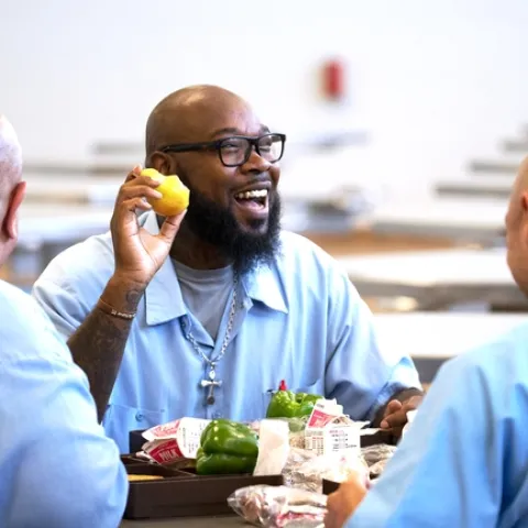 Patrick Range smiles as he holds up a Bartlett pear