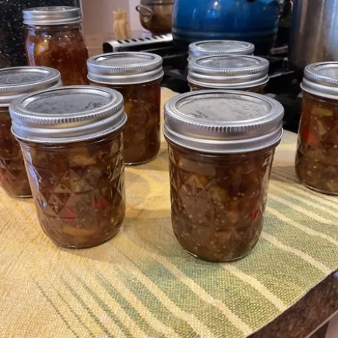 Processed jars resting on towel on counter