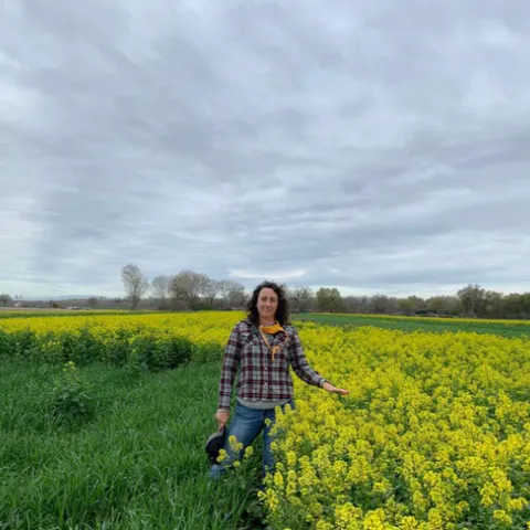 Sarah Light next to a cover crop plot