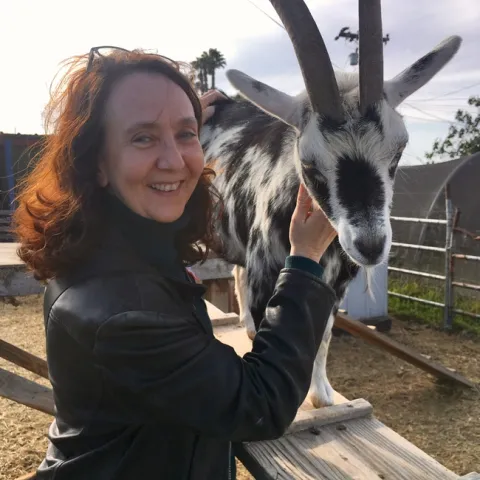 Rachel shown with a black & white goat.