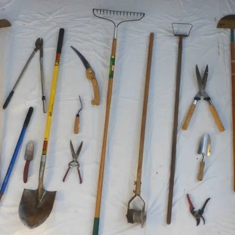 An assortment of tools including pruners, shovels, and hoes.