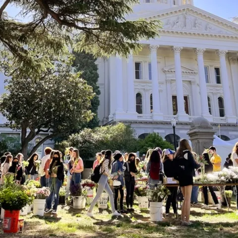 Agriculture event with people and booths in front of the Sacramento state capital.