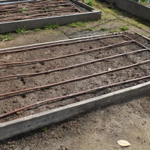 Drip hose arranged on a gardening beg.
