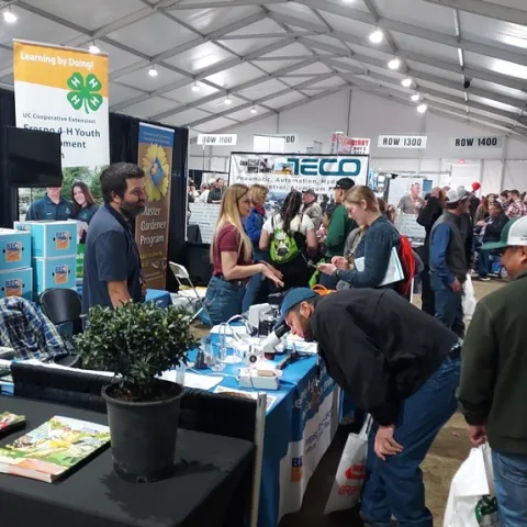 SRAs Brady Holder and Lauren Vuicich provide information from the Kearney booth at World Ag Expo.
