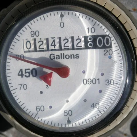 A dial gauge showing water usage of 2,422,880 gallons.