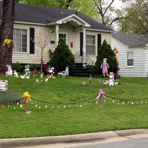 A fun, Easter decorated landscape with a lawn in front of a house.