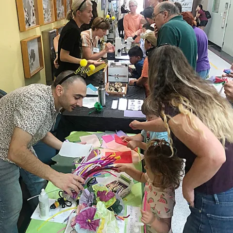The Rachel Vannette lab engages the crowd at the Bohart Museum open house. In front, from back, are doctoral student Dino Sbardellati, associate professor Rachel Vannette, junior specialist Leta Landucci and doctoral candidate Lexie Martin. (Photo by Kathy Keatley Garvey)