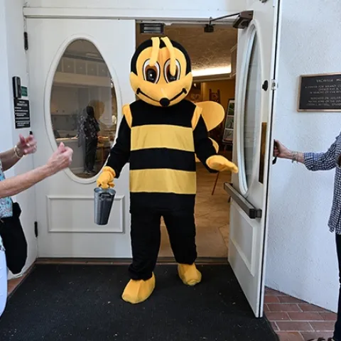 Hear that buzz? The Honey Bee (Dr. George Stock) enters the courtyard. With him are Vacaville Museum Guild members Georganne Gebers (right) of Vacaville, and Sharon Walters of Dixon. (Photo by Kathy Keatley Garvey)