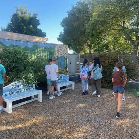 Students at Vintage Parkway School in Oakley explore their garden and the benches where they can relax breathe fresh air. Photo by Amanda Merrill.