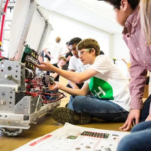 Young people work on a robot