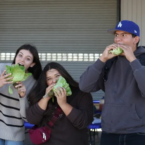 Students from Fullerton Joint Union High School, including Andres Martinez (right), snack on lettuce grown in hydroponics at the South Coast REC. Photo by Saoimanu Sope.