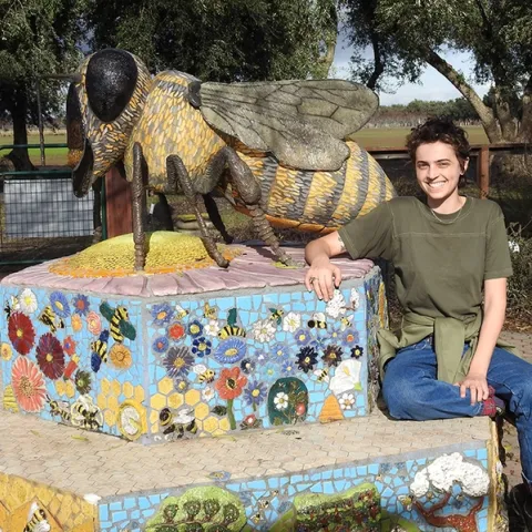 Michelle Monheit of Woodland stands by "Miss Bee Haven," sculpted by Donna Billick. Michelle has visited the garden since childhood when her mother was working on bee research. (Photo by Kathy Keatley Garvey)