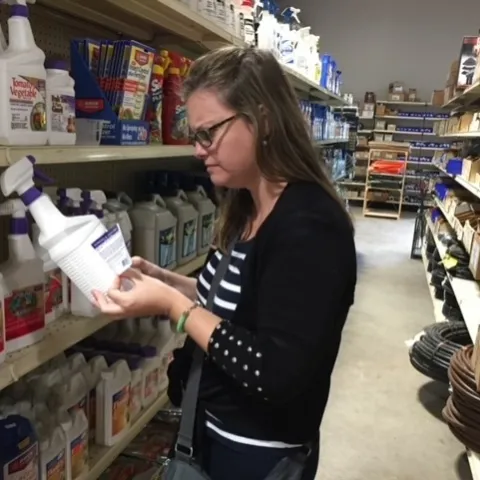 Reading a pesticide label, photo by Natalie Schellman.