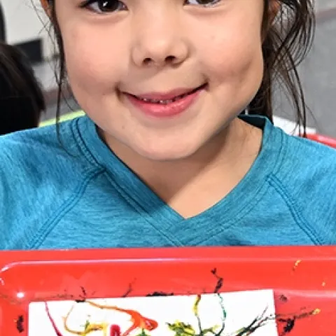 Phoenix Leeper, 6, of Davis shows her masterpiece: maggot art. (Photo by Kathy Keatley Garvey)