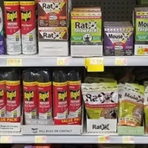 Shelves of various consumer pesticides in a retail store.