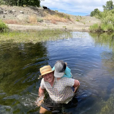 Cleo Woelfle Hazard and his child visit a beaver dam analog