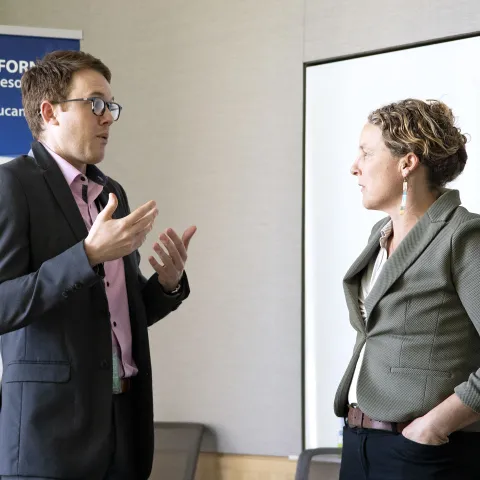 Lenya Quinn-Davidson at right talks with a legislative aide