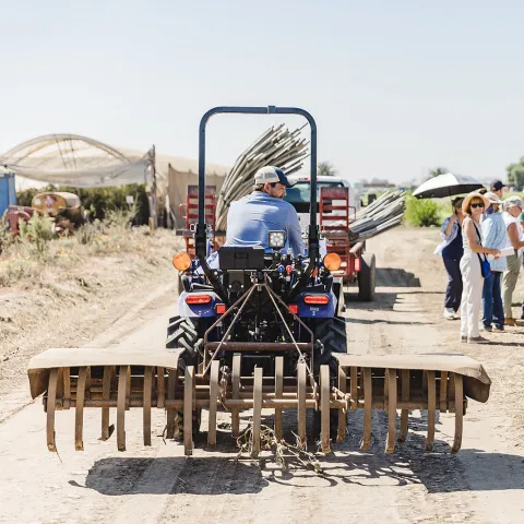 Man dragging dirt road 