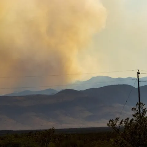 Hills with smoke in the distance