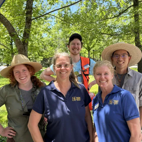 Fire and forestry team members smile amid trees