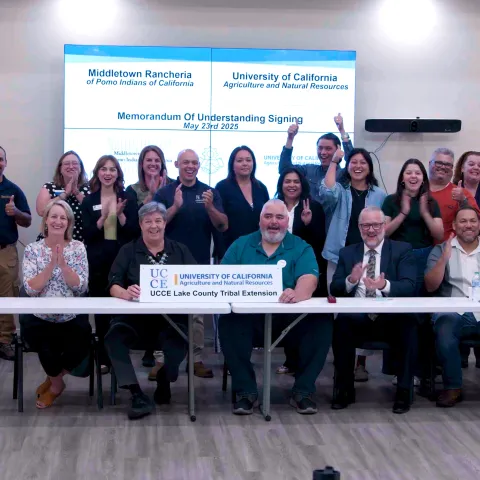 UC ANR teams, Middletown Rancheria leaders and county officials pose to celebrate MOU signing