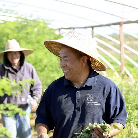 Michael Yang turns, smiling, at a guy behind him