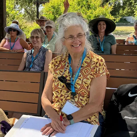 Master gardener students meet int he outdoor classroom in the demonstration garden