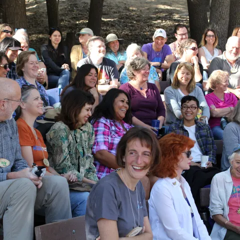 a group of people are talking and laughing