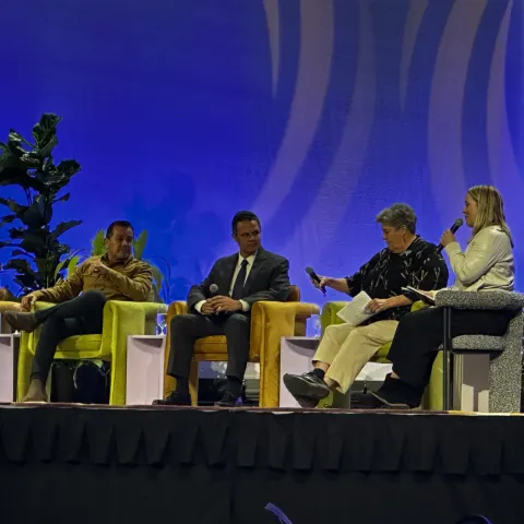 Five people seated on stage