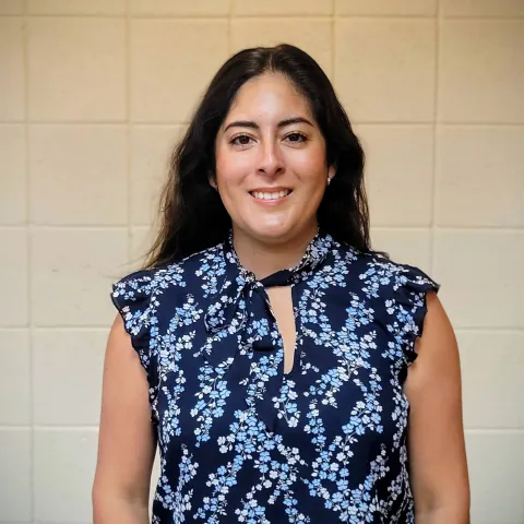 New forestry advisor standing before a white wall