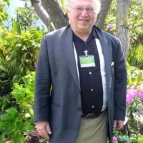 David Zilberman stands in a garden