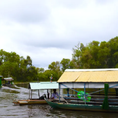 Covered boats float down on the water