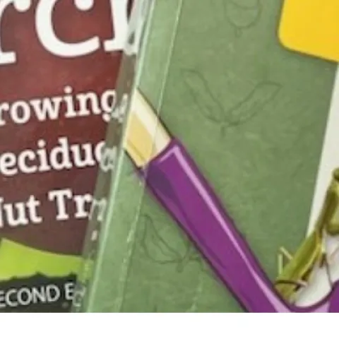 three gardening books and a spiral bound resource on bees