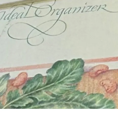 a pastel colored garden journal with a rubber band around the journal