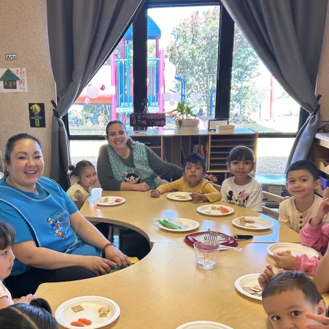 Teachers guide preschool students through Fuel Their Minds tasting activity with garbanzo bean hummus dip, whole wheat crackers, and carrots.