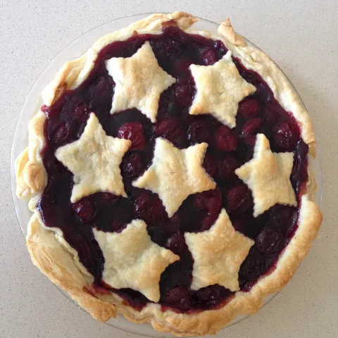 Photo of cherry pie with star pattern on top crust 