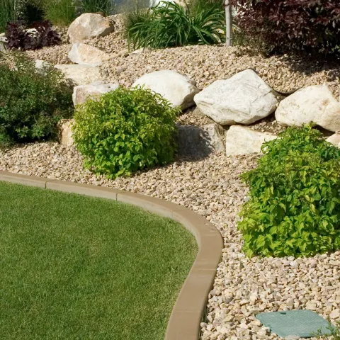 Drought tolerant landscape with rocks, grass and shrubs.