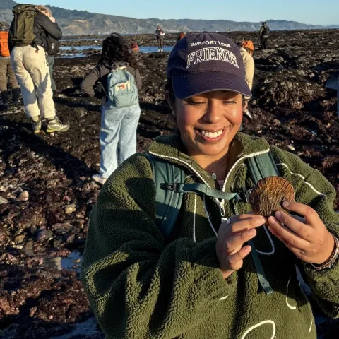 Daisy Prado holds a shell as she explores Duxbury Reef as part of a UC California Naturalist course excursion