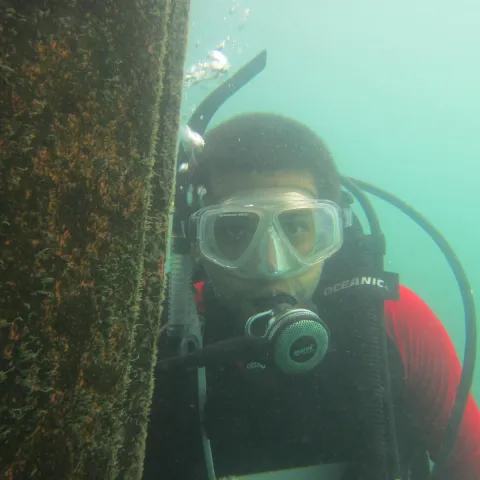 Photograph of Chris Scianni scuba diving under water.