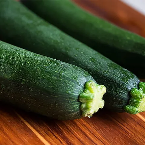 3 zucchini on a wooden board