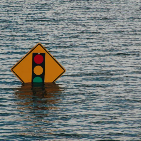 street sign halfway under water due to flood