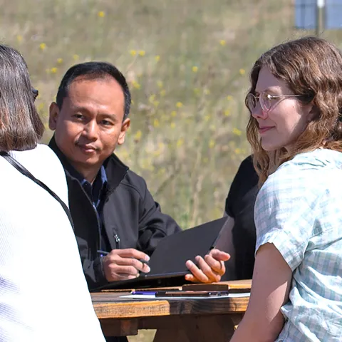 ANR staff talking at picnic table