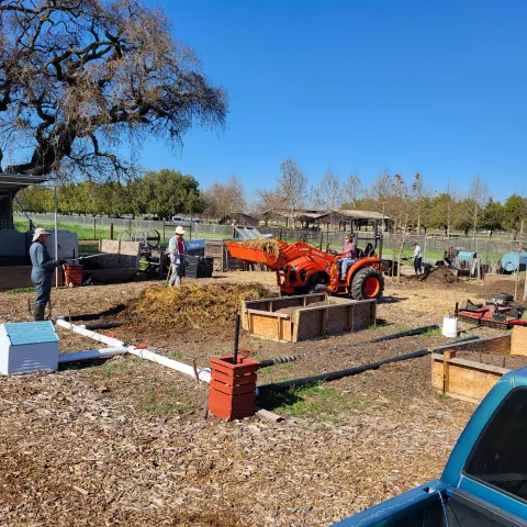 An aerated static pile (ASP) being constructed using a tractor