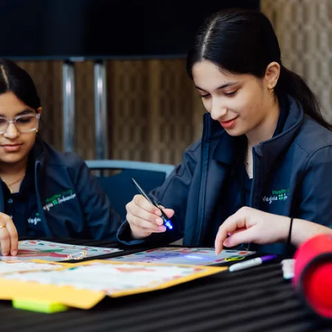 Youth at a table doing an art project.